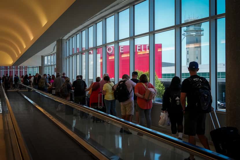 Passengers wait to re-enter Dallas Love Field Airport on July 25, 2022 after a ground stop.