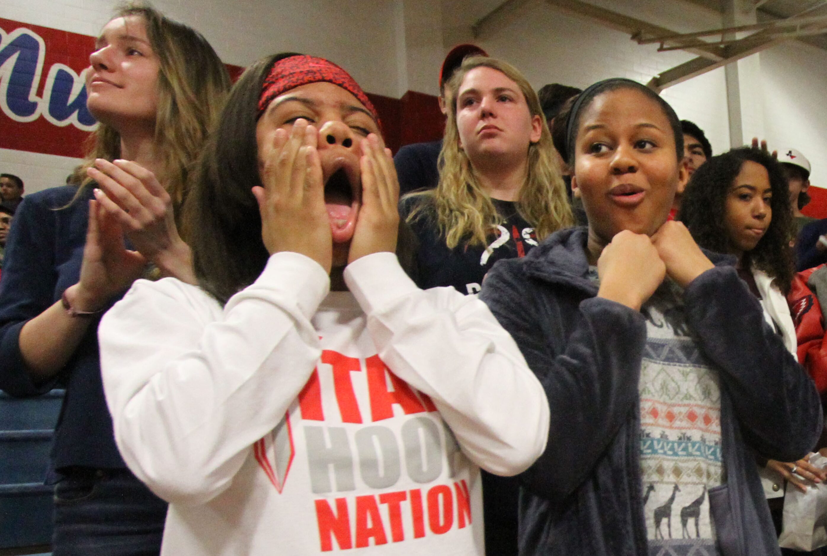 Frisco Centennial sophomore Majesty Parker shows the pain, as other fans react to a Titans...