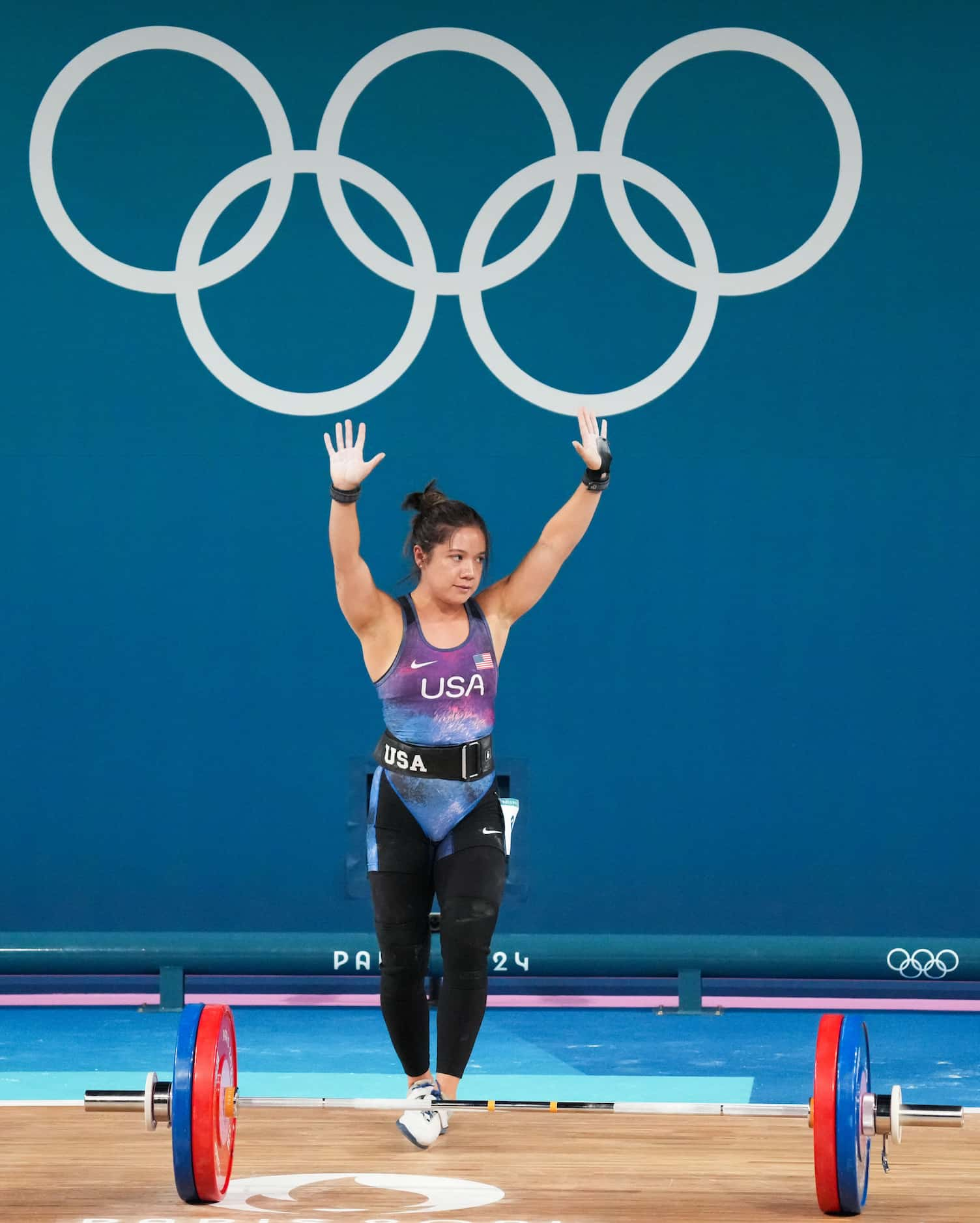 Jourdan Delacruz of the United States reacts after lifting 111kg in the clean and jerk...