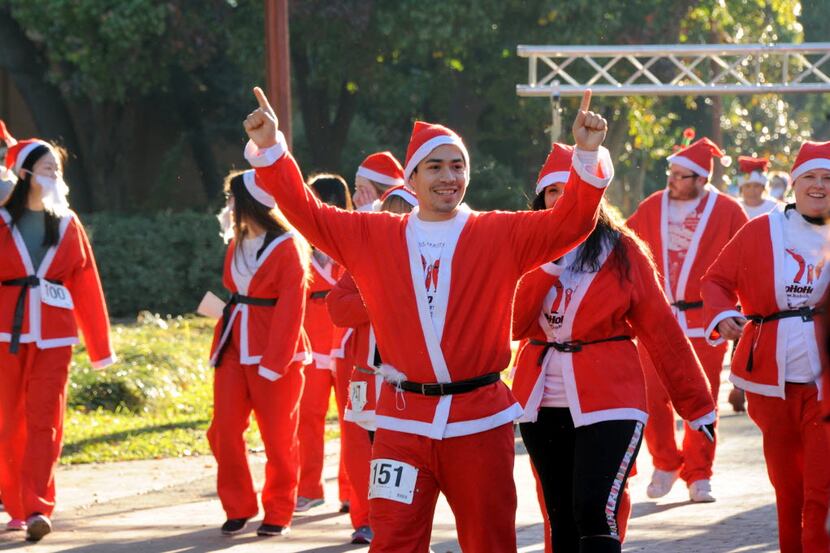 A runner races to the finish line at the Ho Ho Ho Run at Fair Park in Dallas, TX on December...