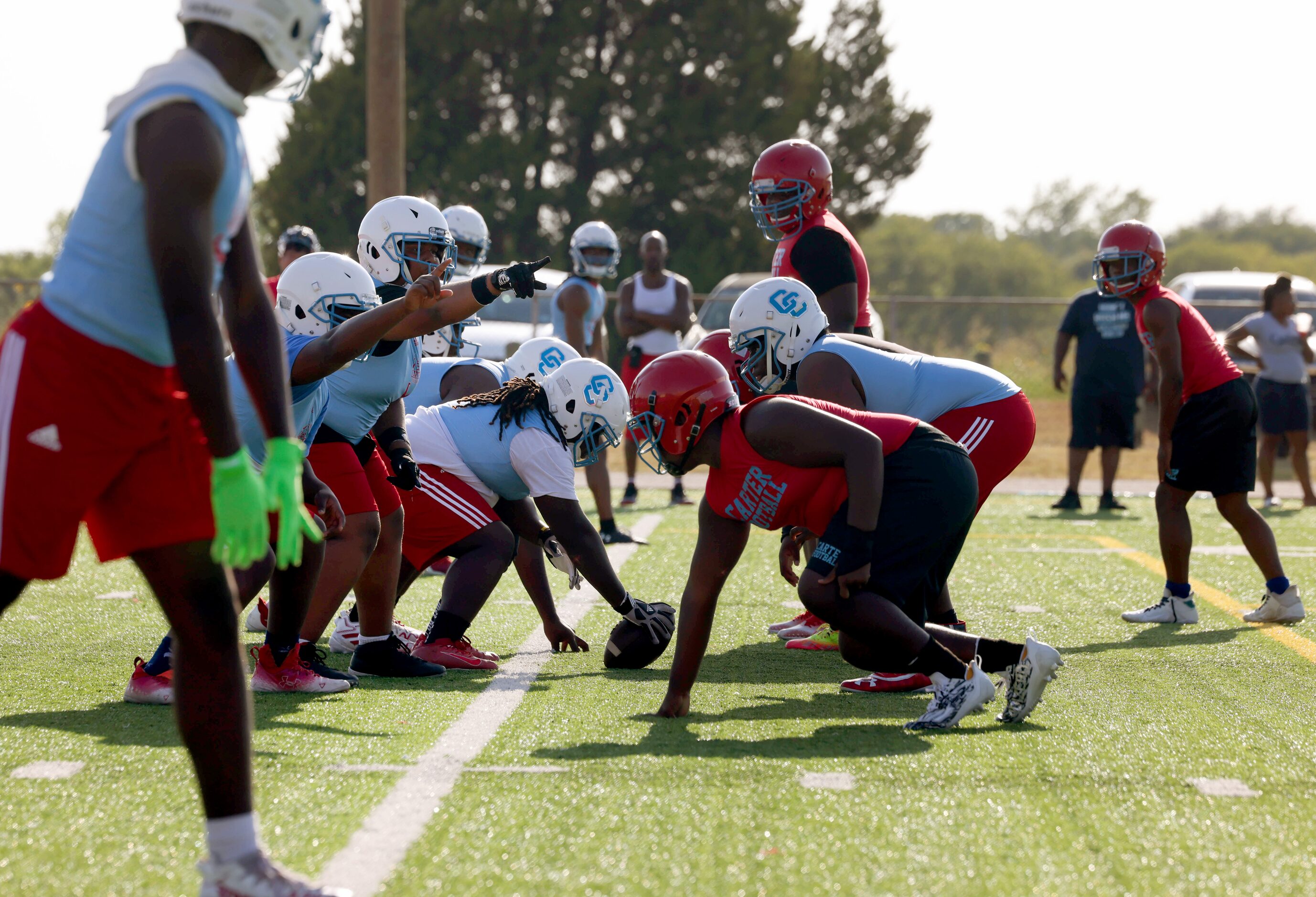 Two players point in the direction of play before a drill at the first practice of the...