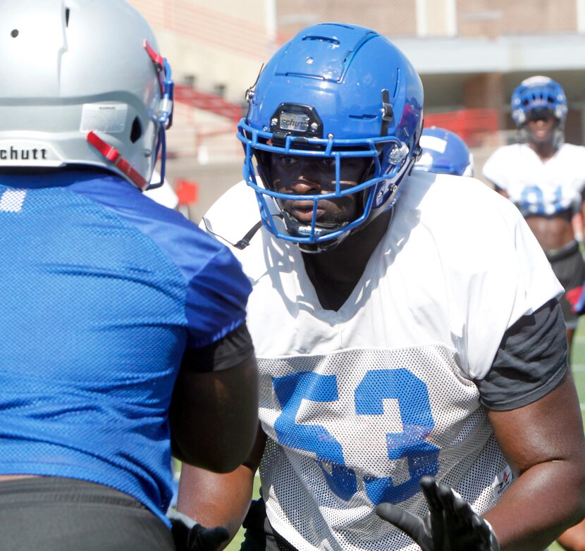 Duncanville offensive lineman Jaylen Early (53) works to maintain a block on a defender...