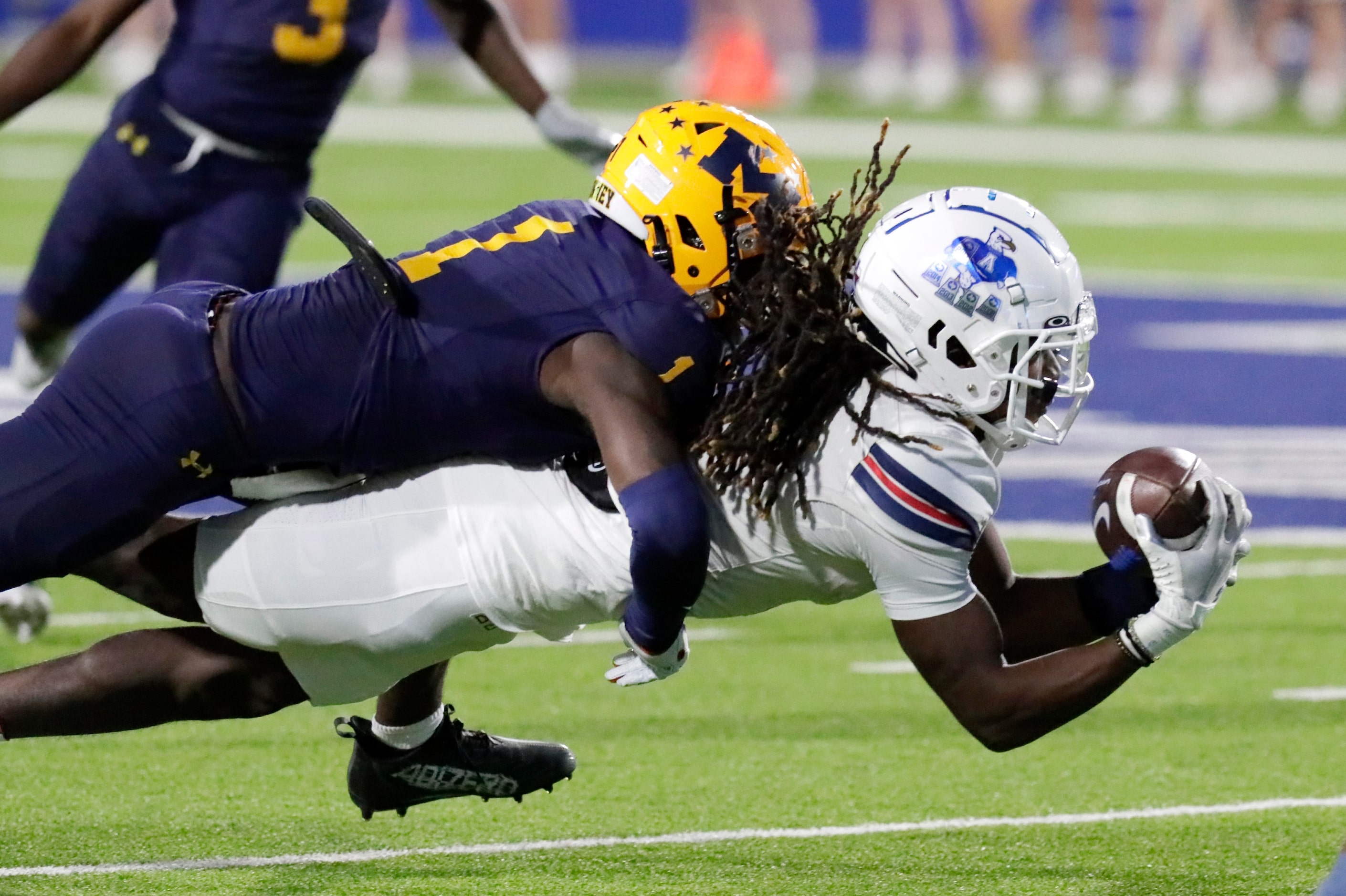 Allen High School wide receiver Messiah Washington (4) is tackled by McKinney High School...