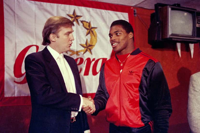 FILE - In this March 8, 1984, file photo, Donald Trump shakes hands with Herschel Walker in...