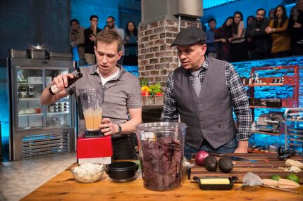 Braden Wages, on left, cooks while chef Michael Symon looks on. Symon and chef Daphne Oz...