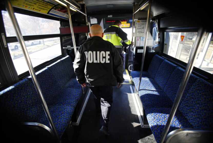 DART police Sgt. John Kusewitt, followed by Officer P.C Wong, disembarks from a bus at...
