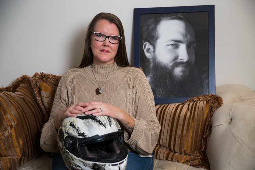 Melissa Howell poses for a portrait with a photo of her son, Braxton Brock, and his helmet...