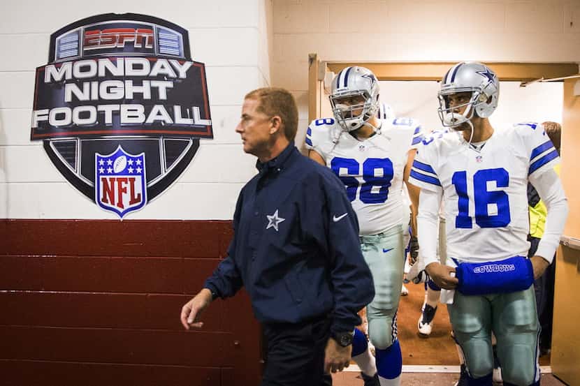 Dallas Cowboys head coach Jason Garrett leads tackle Doug Free (68) and quarterback Matt...