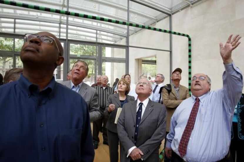 Dallas Police and Fire pension trustees  look up at the Museum Tower during an October 2012...