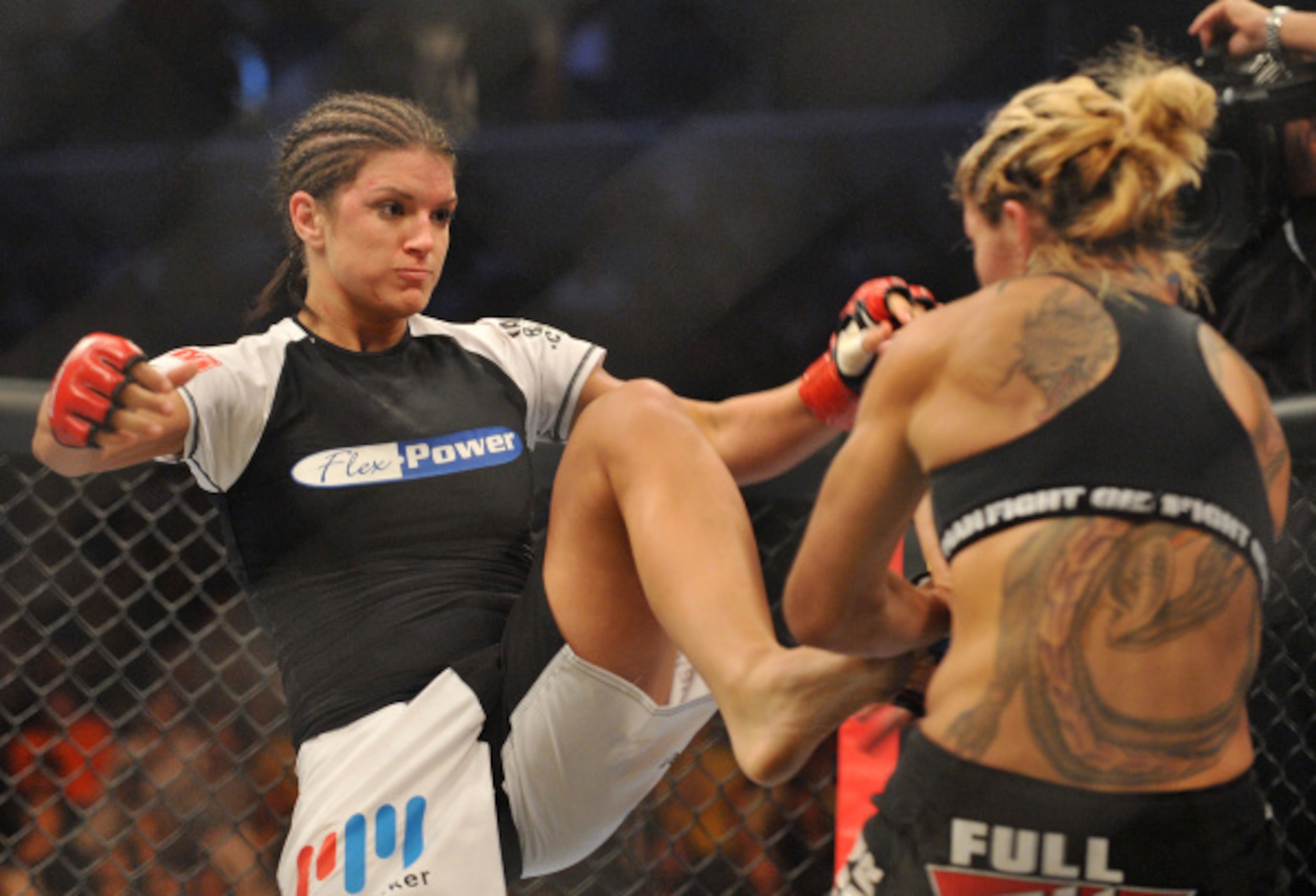 Cris Cyborg (R) battles Gina Carano during their Middleweight Championship fight at...