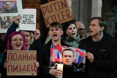 Protesters stage a demonstration opposite the Russian Embassy in London on Friday in...