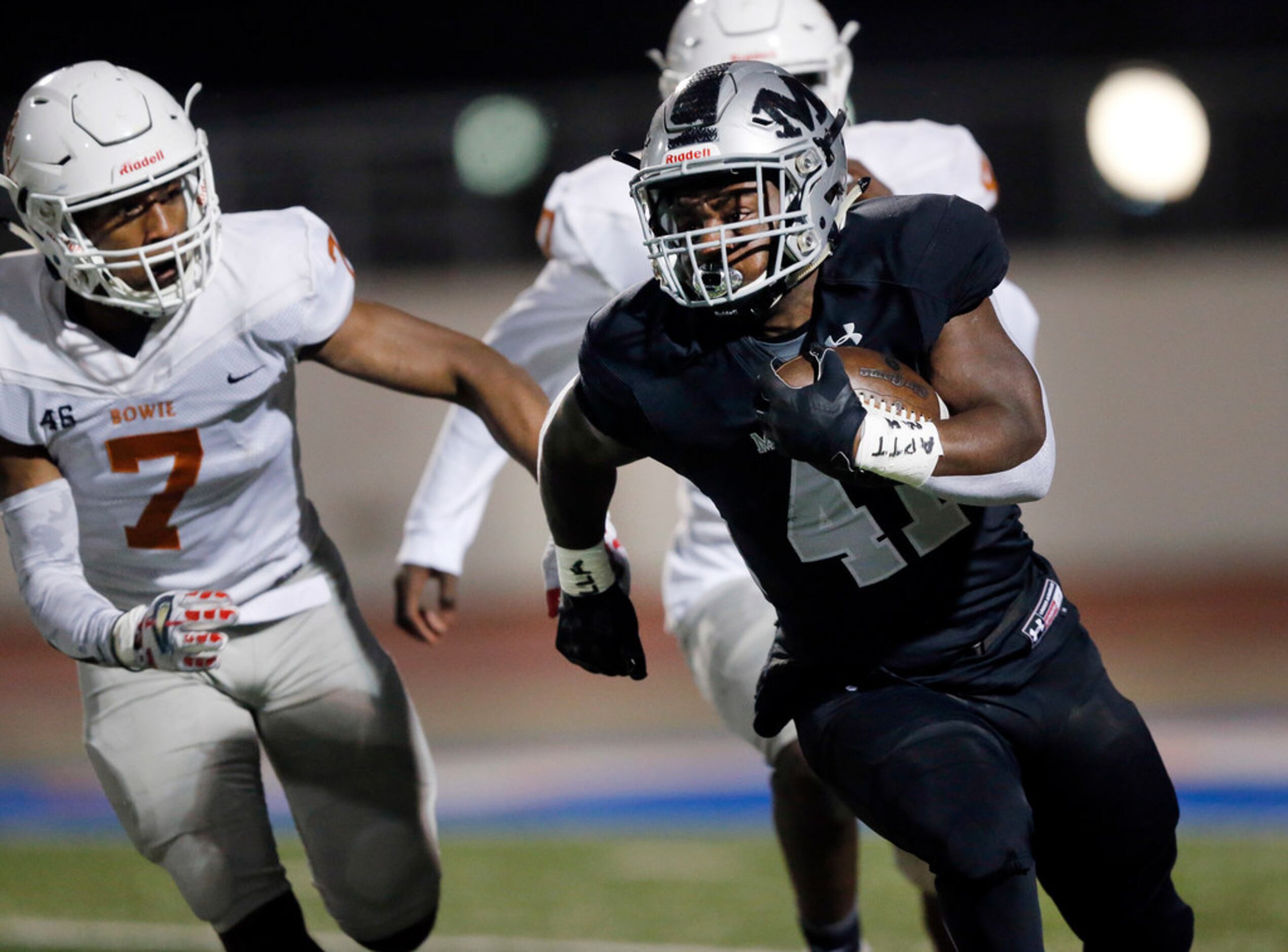 Martin High running back Julian Johnson (41) carries the ball around the end as he's pursued...