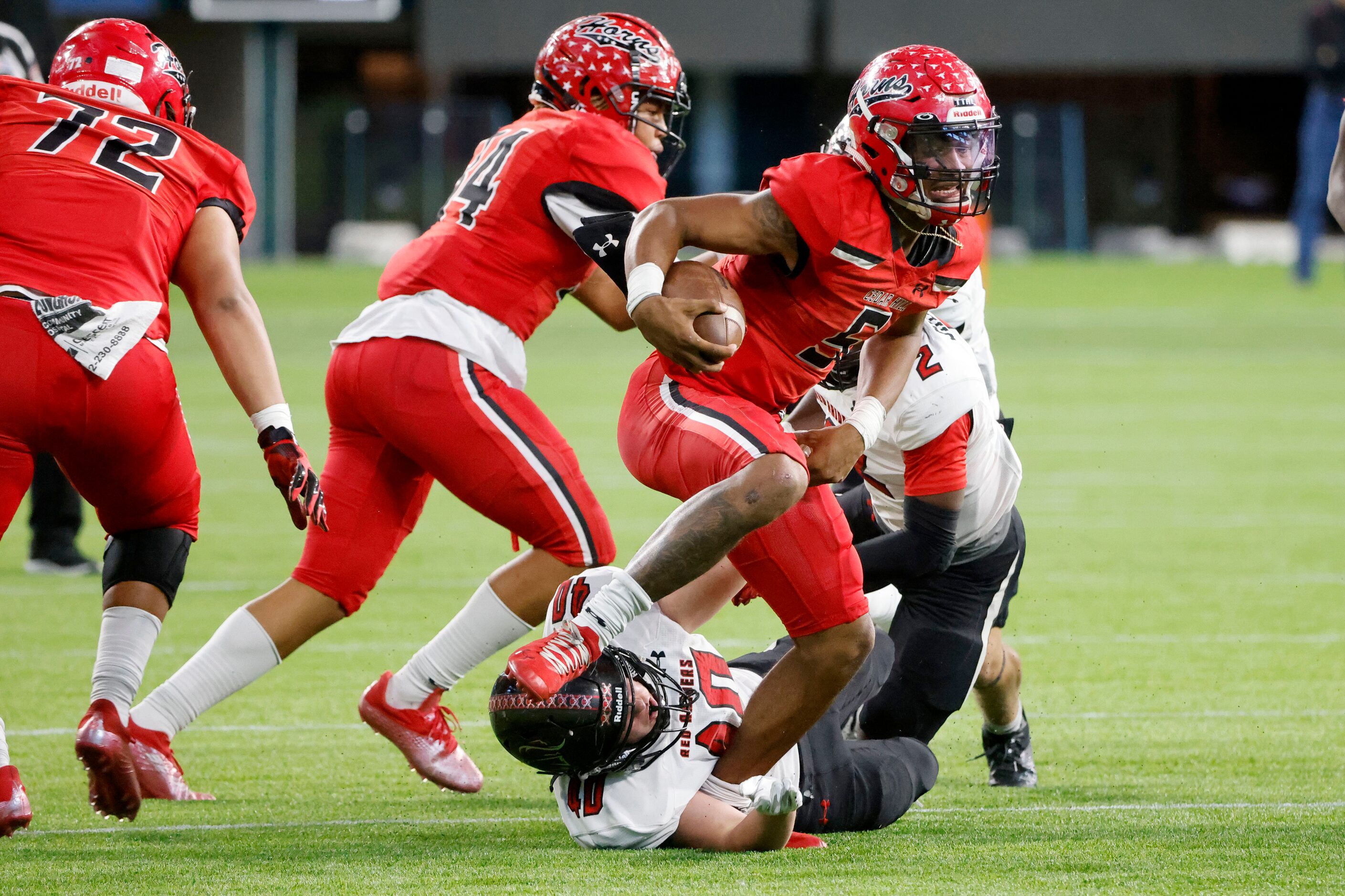 Cedar Hill quarterback Cedric Harden Jr. (5) breaks free of a tackle by a Tyler Legacy...