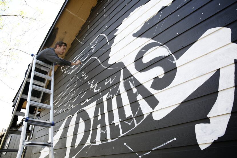 Will Heron, also known as Wheron, works on his mural "Dallaxy" at The Platform, his gallery...