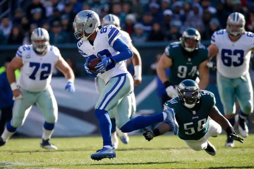 Dallas Cowboys wide receiver Terrance Williams (83) gets away from a tackle attempt by...
