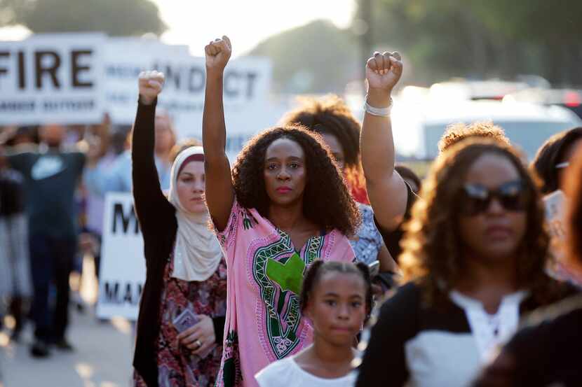 Demonstrators marched around AT&T Stadium in Arlington ahead of an NFL game between the...