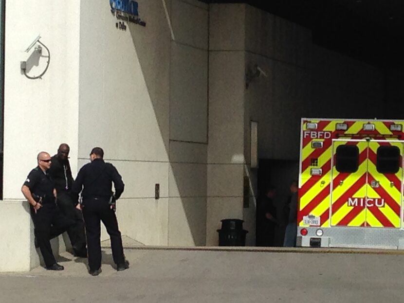 Dallas police officers wait outside Baylor University Medical Center in Dallas, as they...