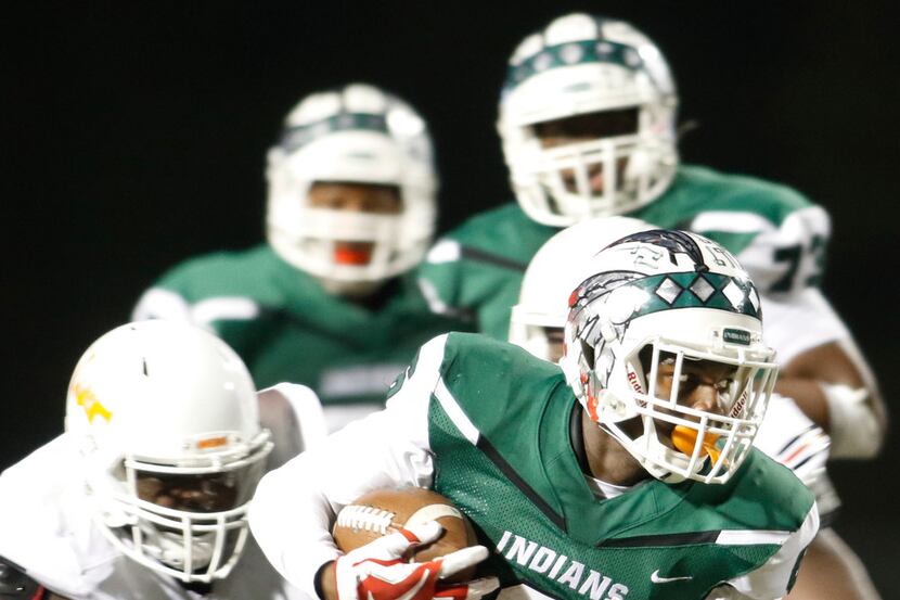 Waxahachie's Demani Richardson (6) rushes for a first down during first quarter action...
