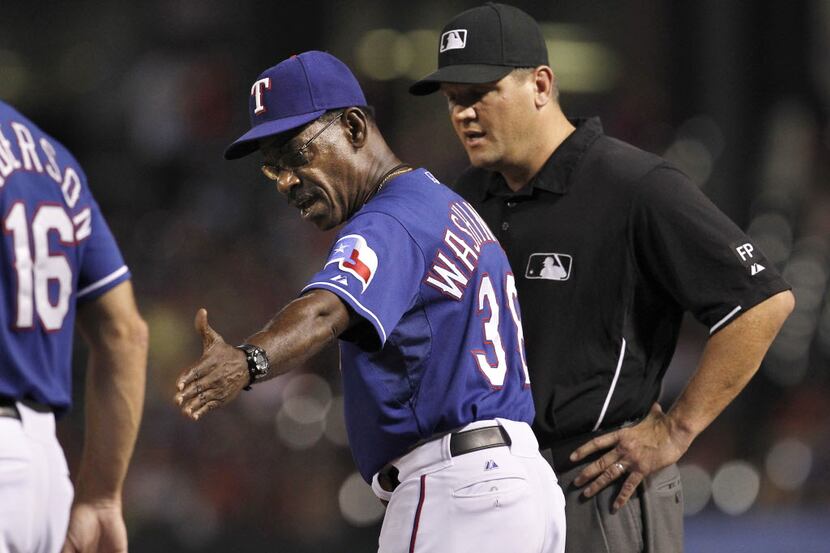 Texas Rangers manager Ron Washington (38) argues a call made by umpire Chad Fairchild (75)...
