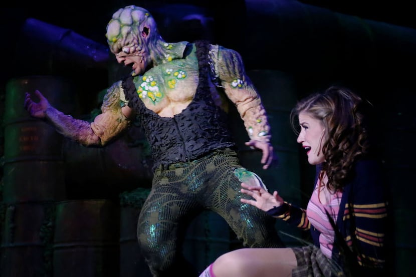 The Toxic Avenger (John Campione, center), is in love with Sarah the Blind Librarian (Katie...