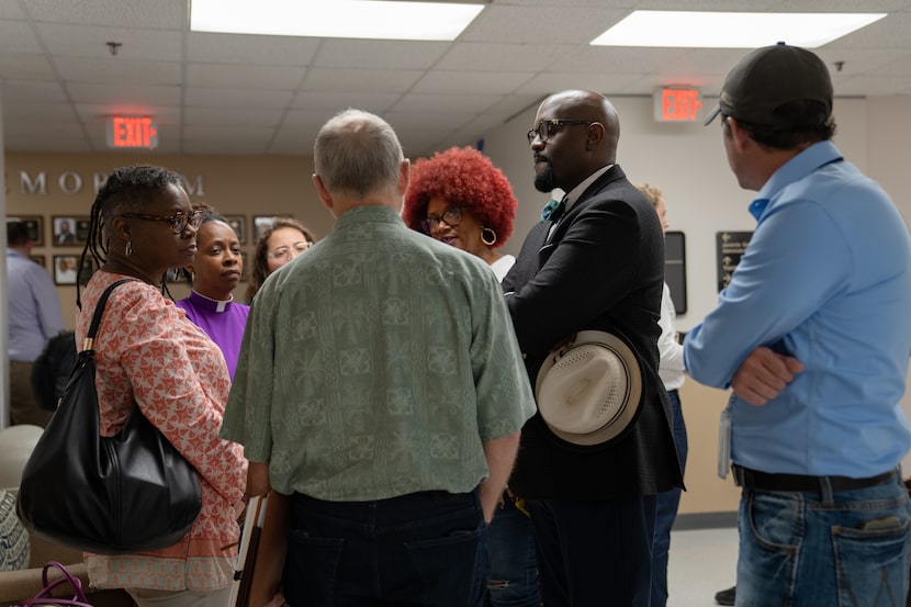 The Rev. Michael W. Waters speaks with other attendees at a Dallas County Juvenile Board...