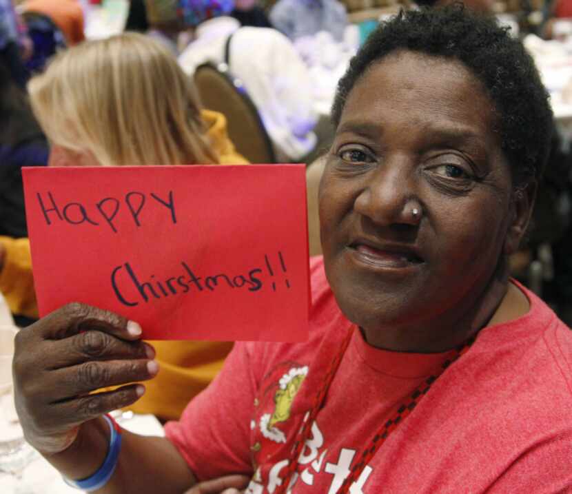 Carol "Mama" Hawkins, 58, is all smiles after receiving a Christmas card at her table during...