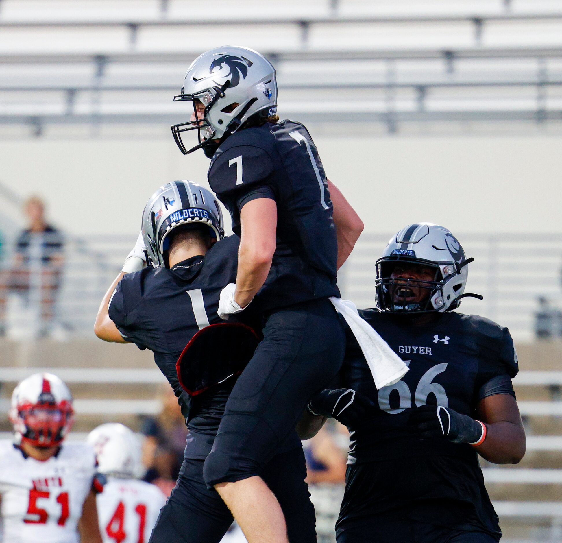 Denton Guyer wide receiver Landon Sides (7) celebrates a touchdown with wide receiver Bryson...