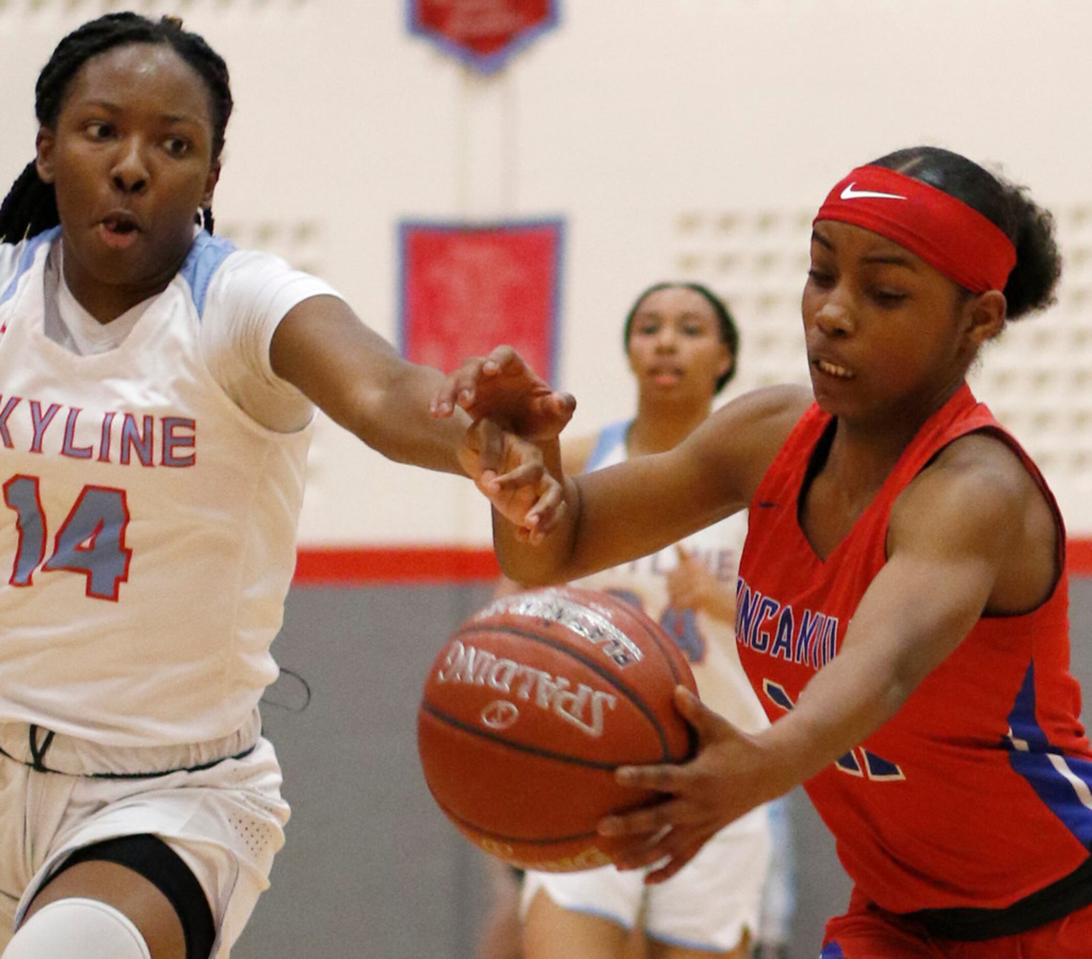 Duncanville's Tristen Taylor (11) battles Dallas Skyline's Daryn Batts (14) for ball...