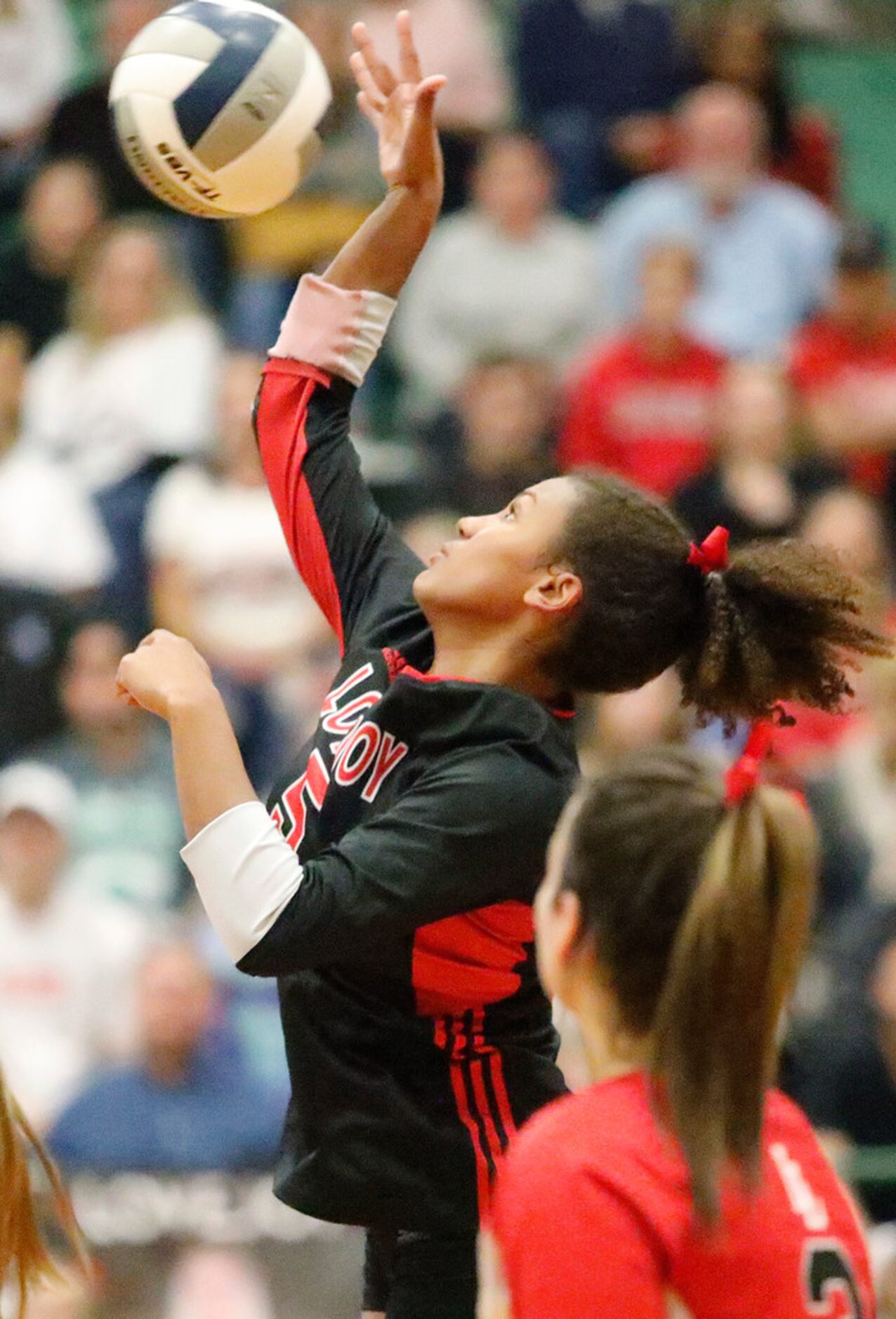 Lovejoy High School outside hitter Cecily Bramschreiber (5) gets the ball over the net in...