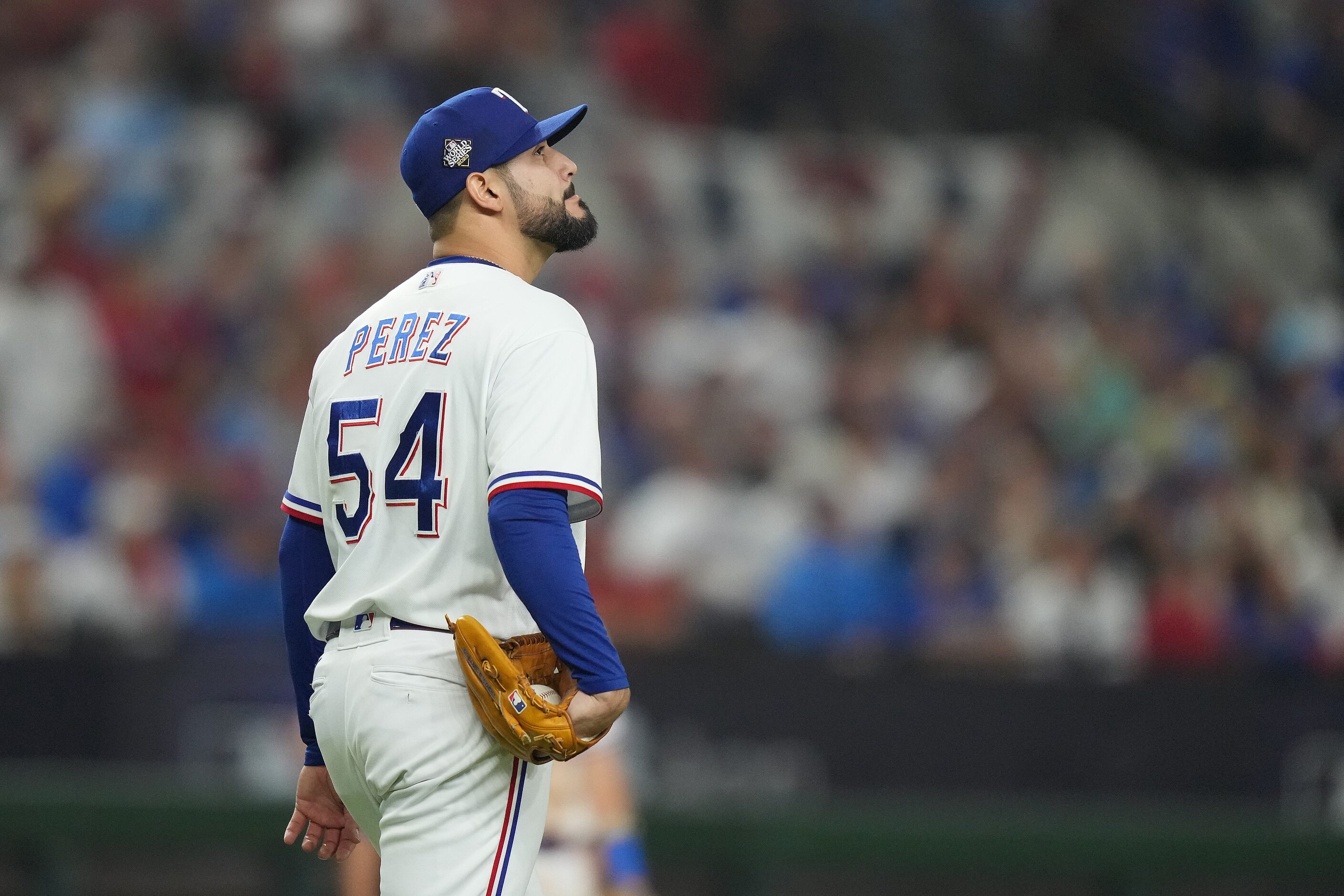 Texas Rangers pitcher Martin Perez reacts after giving up a two-run single to Arizona...