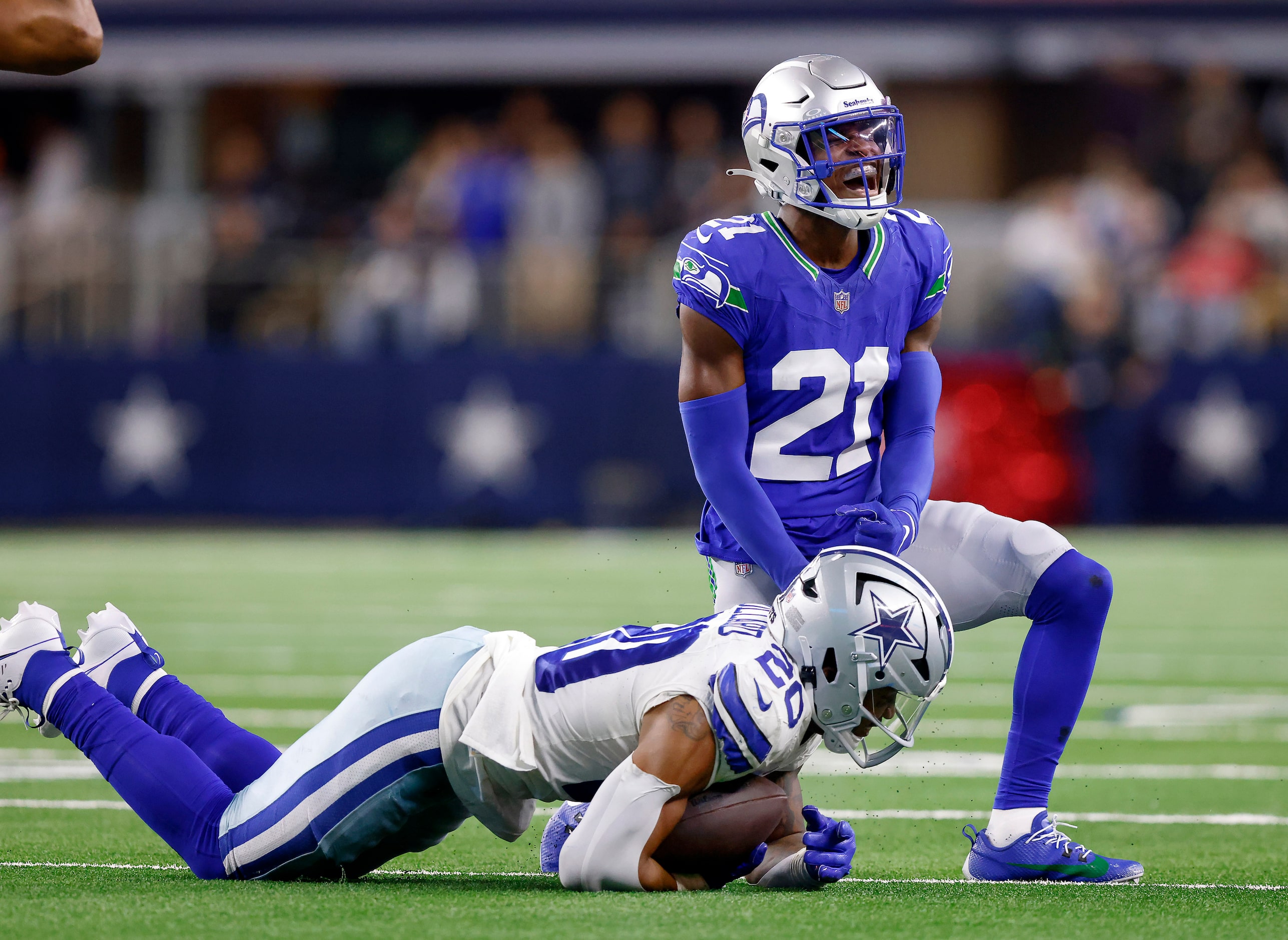 Seattle Seahawks cornerback Devon Witherspoon (21) celebrates a stop of Dallas Cowboys...