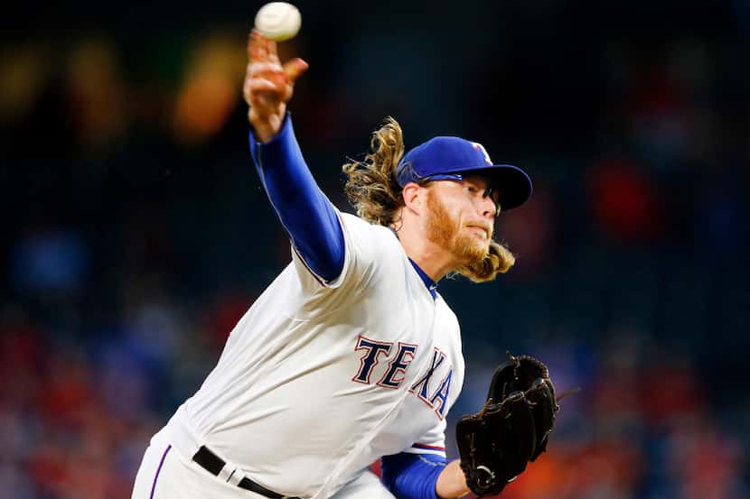 Texas Rangers starting pitcher A.J. Griffin (64) throws against the Milwaukee Brewers in the...