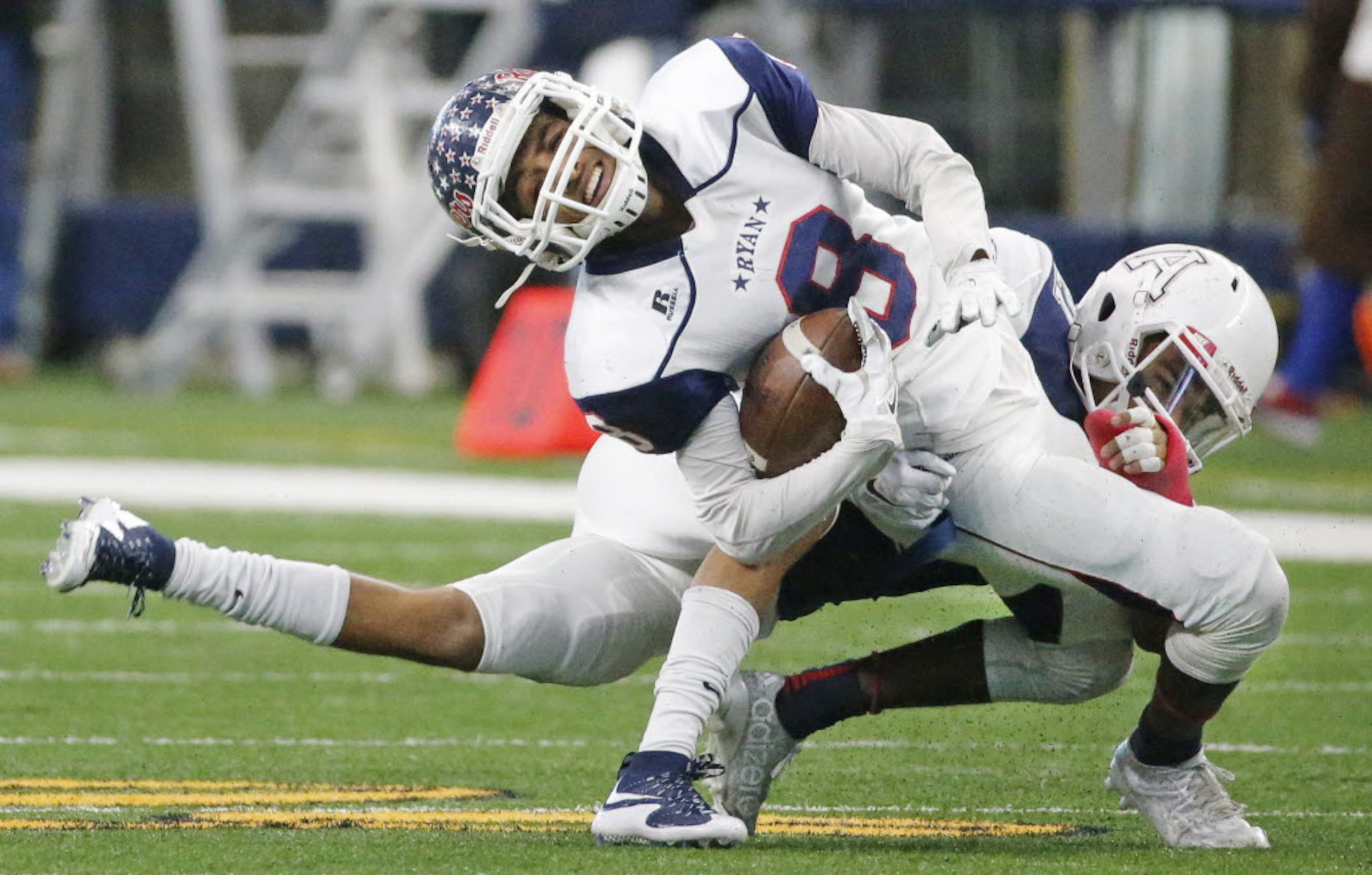 Ryan receiver Rodney Gladney (8) grimaces on a hit by Allen's Jaylen Ellis in the second...