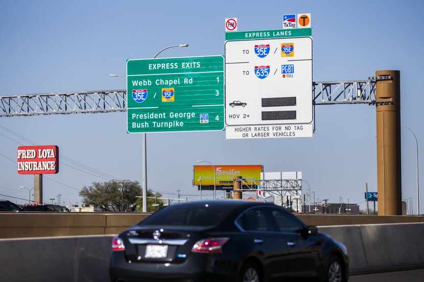 Motorists drive west on LBJ Freeway at the entrance of the TEXpress toll lanes on Tuesday,...