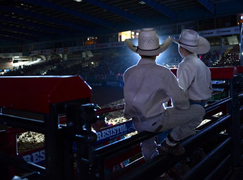 Youth bull riders Garrett Gonzalez and Riggen Hughes watch a performance at the Mesquite...