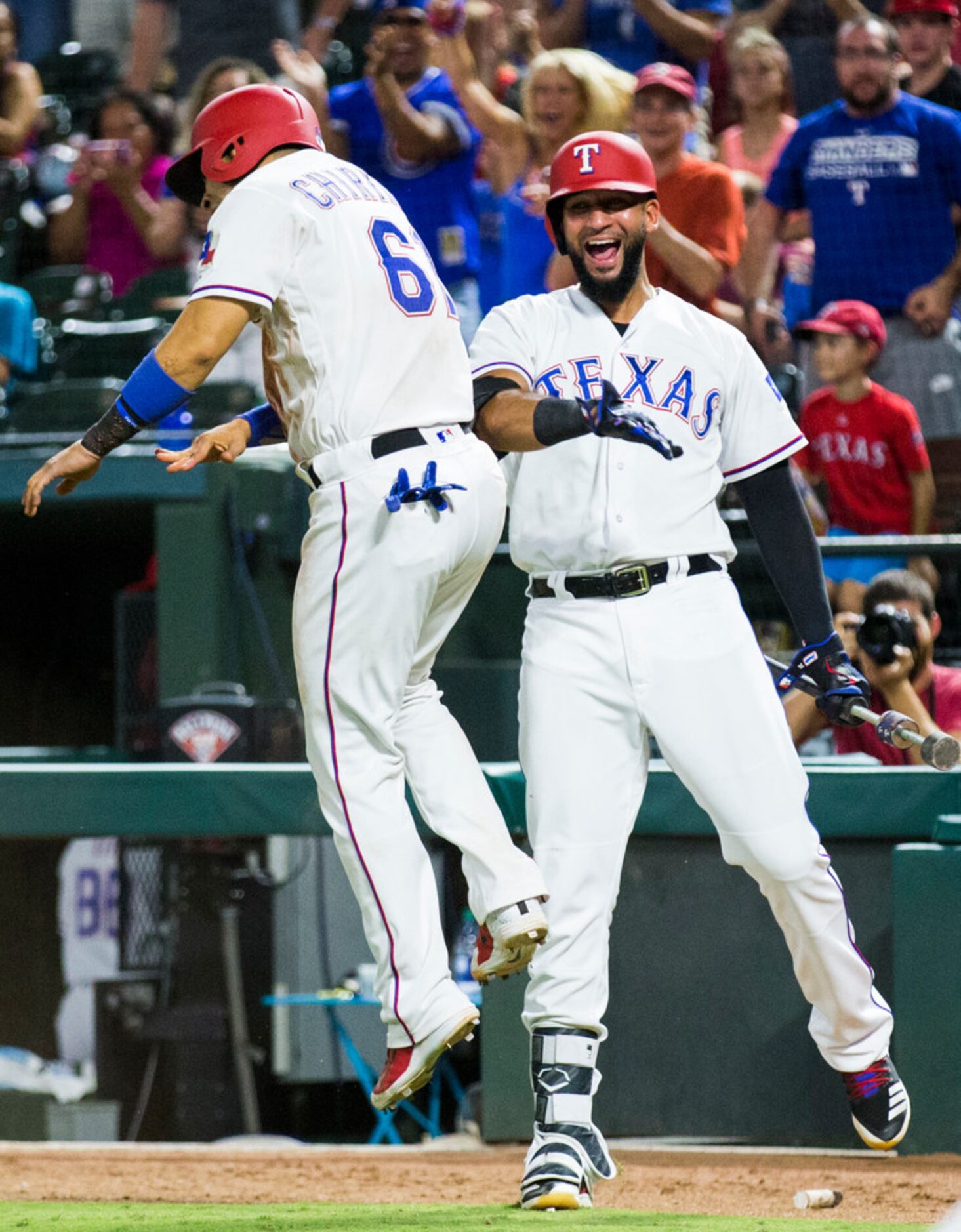 Texas Rangers catcher Robinson Chirinos (61) celebrates with right fielder Nomar Mazara (30)...