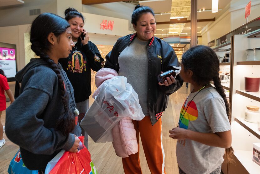 Mariana Castillo (far left), 9, and her aunt Gabinna Bazan watch as Gabby Bazan, center,...