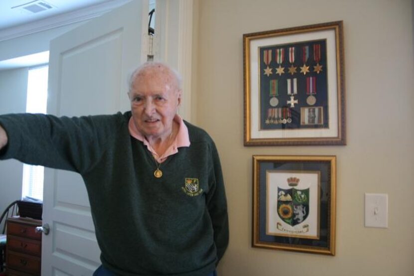 
Lake Highlands resident Dennis King stands next to a case displaying medals from his...