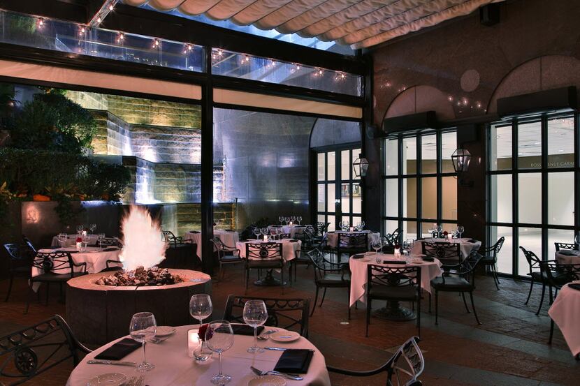 The dining room Dakota's Steakhouse looks out onto a patio garden with a waterfall.