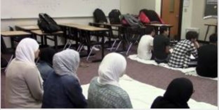 Liberty High School students use an empty classroom to pray. The school has been offering...