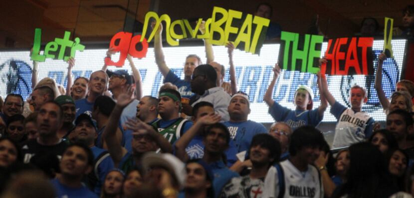 Fans cheer for the Mavericks during the watch party at the American Airlines Center in...