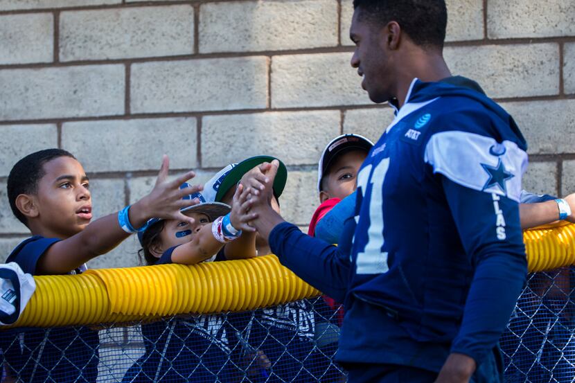 Dallas Cowboys cornerback Byron Jones (31) high-fives young fans during afternoon practice...