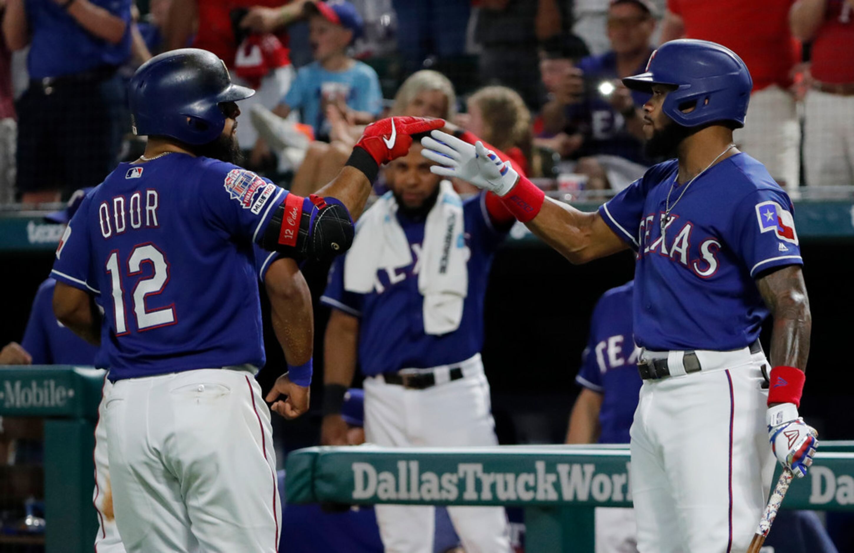 Texas Rangers' Rougned Odor (12) and Delino DeShields, right, celebrate Odor's two-run home...