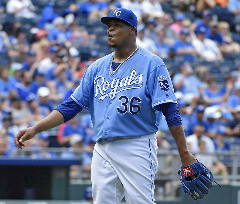 Kansas City Royals starting pitcher Edinson Volquez reacts to an RBI single by Texas...