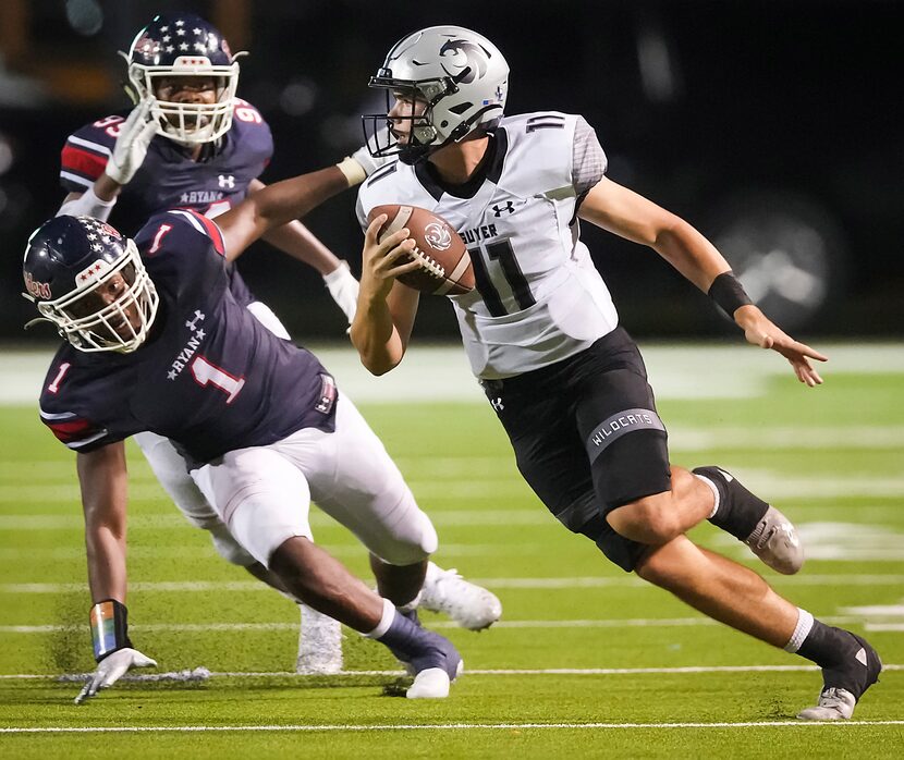 Denton Guyer quarterback Jackson Arnold (11) scrambles away from Denton Ryan defensive...