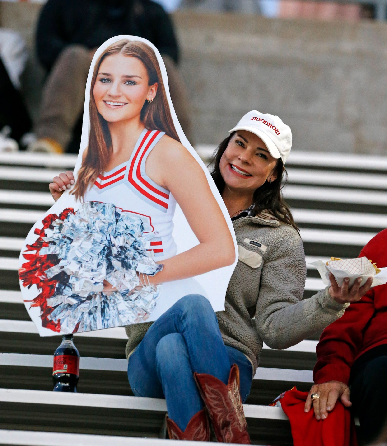 A Woodrow Wilson High fan holds a blowup of a cheerleader during the first half of a high...