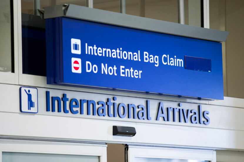 A sign for the international arrivals terminal at DFW International Airport on Wednesday,...