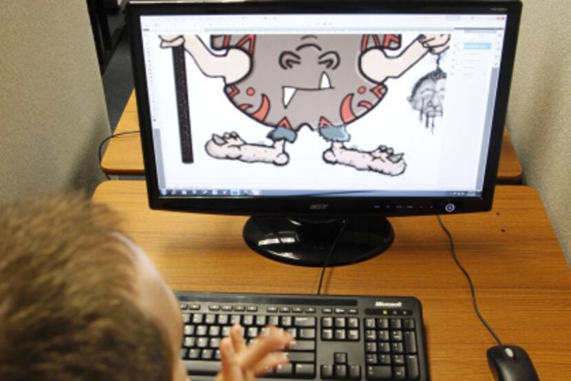 Teacher Andrew LaBounty (front) of Allen works on a game character graphic with student...