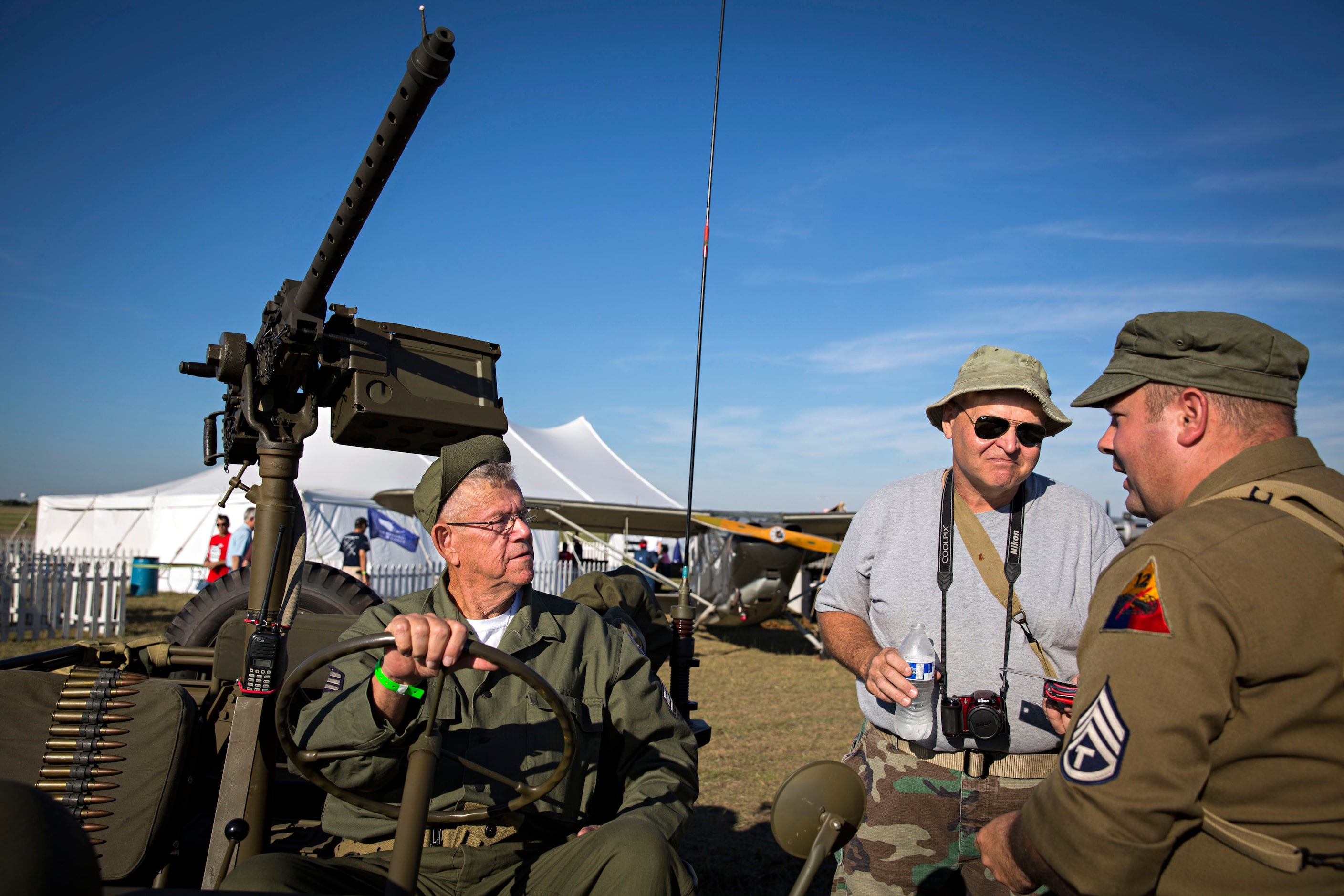 (From left) World War II re-enactors John Roberts (left) and Andrew Wells talk with John...