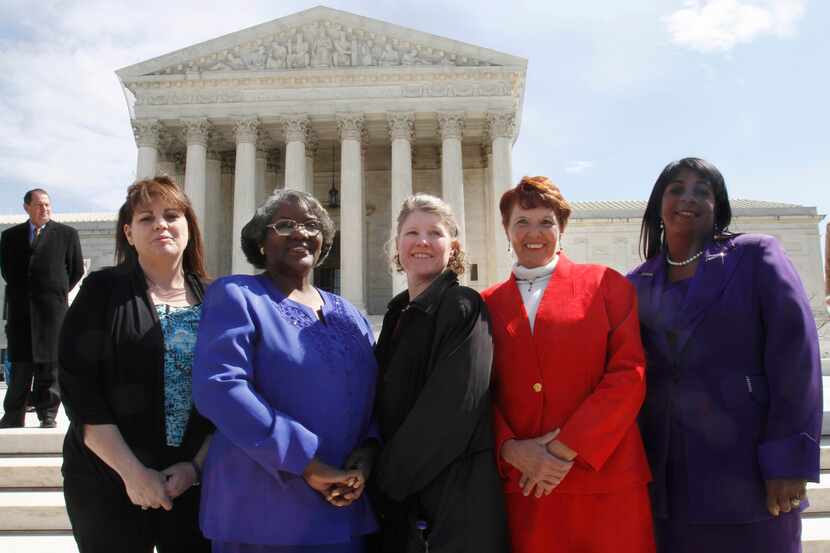FILE - In this March 29, 2011 file photo, the five plaintiffs in a case of women employees...